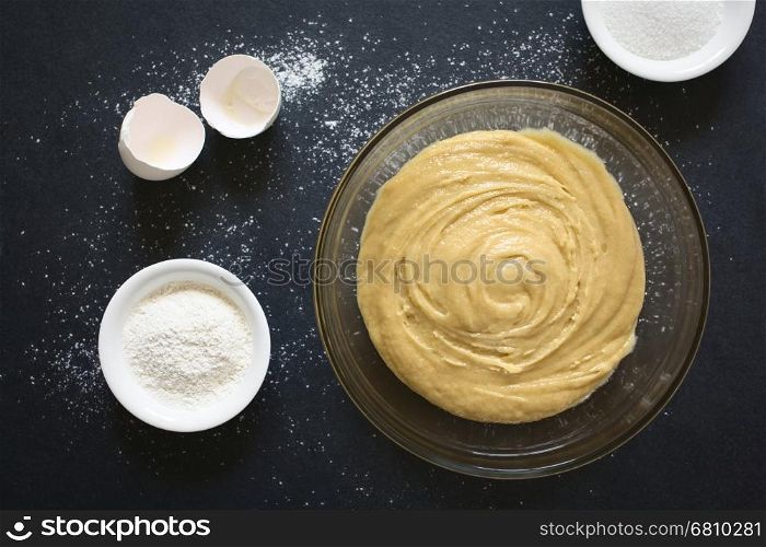 Basic homemade cake or cookie dough in glass bowl with ingredients on the side, photographed overhead on slate with natural light (Selective Focus, Focus on the dough)