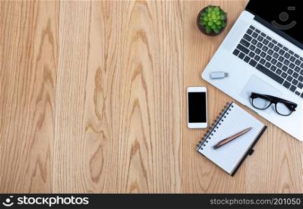 Basic office technology and writing stationery on wooden desktop  