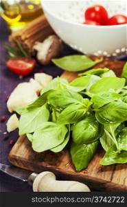 Basil and ingredients for making italian pasta