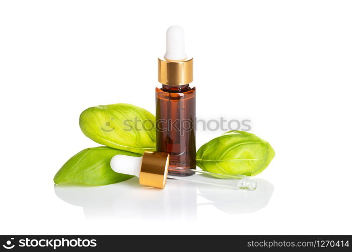 Basil essential oil bottle with dropper isolated on white background. Basil oil for skin care, spa, wellness, massage, aromatherapy and natural medicine