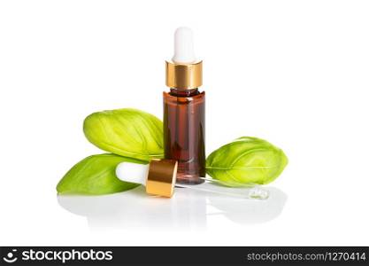 Basil essential oil bottle with dropper isolated on white background. Basil oil for skin care, spa, wellness, massage, aromatherapy and natural medicine