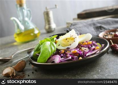 basil leaf, cabbage, corn and boil egg, lime on brown hard gray table texture on background.