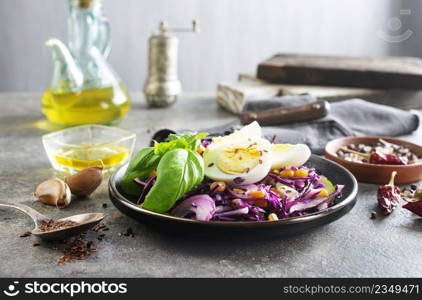 basil leaf, cabbage, corn and boil egg, lime on brown hard gray table texture on background.