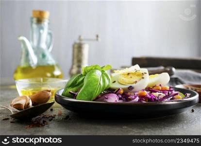 basil leaf, cabbage, corn and boil egg, lime on brown hard gray table texture on background.