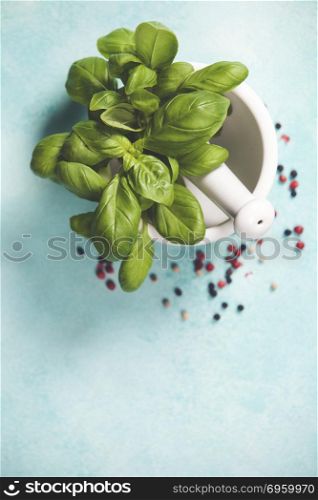 Basil leaves with Mortar and Pestle on rustic blue background. Basil leaves with Mortar and Pestle