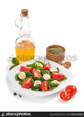 basil, mozzarella and tomato salad isolated on white background
