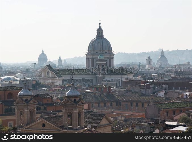 Basilica church of San Carlo al Corso in the skyline of Rome Italy with smog in the distance