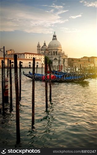 Basilica di Santa Maria della Salute and gondolas at sunset in Venice, Italy