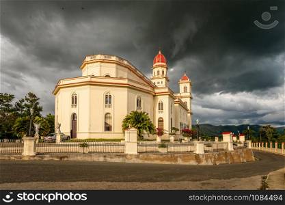 Basilica in honour of Our Lady of Charity, El Cobre with black thunder clouds above, Santiago de Cuba, Cuba