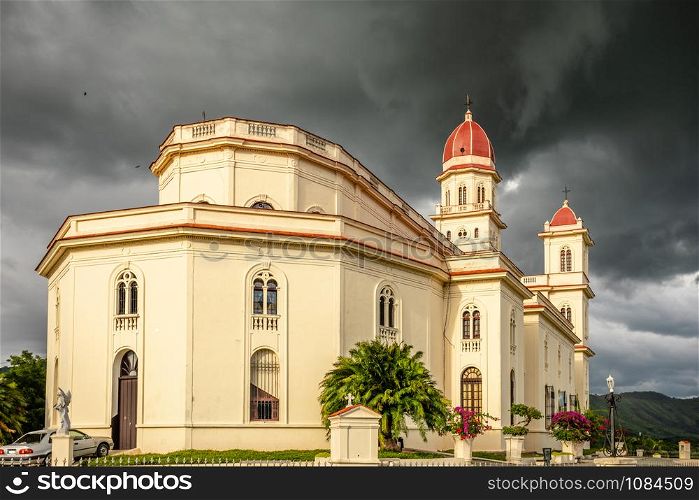 Basilica in honour of Our Lady of Charity with black thunder clouds above, El Cobre, Santiago de Cuba, Cuba