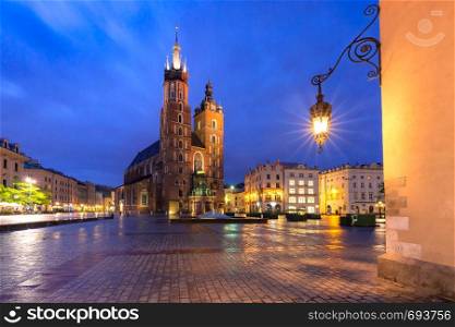 Basilica of Saint Mary on Medieval Main market square in Old Town on the rainy night, Krakow, Poland. Main market square, Krakow, Poland