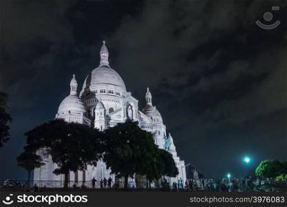Basilica Sacre Coeur in Montmartre at night. Landscape format with copy space in sky.