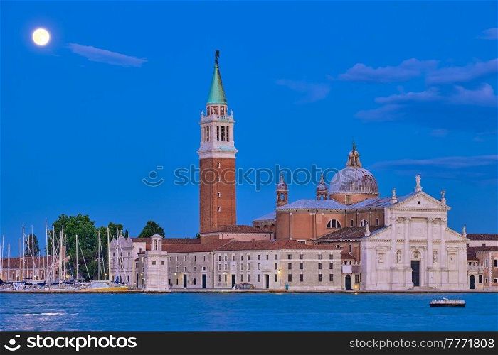 Basilica San Giorgio Maggiore Church seen across the Venice lagoon with full moon. Venice, Italy. San Giorgio Maggiore Church with full moon. Venice, Italy