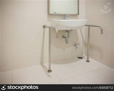 Basin in disabled toilet with copy space