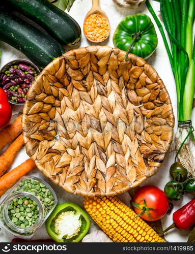 Basket and fresh vegetables. On rustic background .. Basket and fresh vegetables.