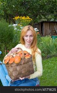 Basket, full mushrooms, and young woman-mushroom picker