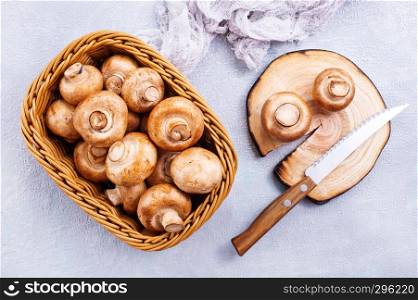 basket of champignon mushrooms on old table
