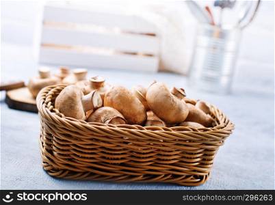 basket of champignon mushrooms on old table