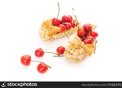 Basket of fresh sour cherries isolated on white