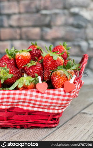 Basket of fresh strawberries on an antique table
