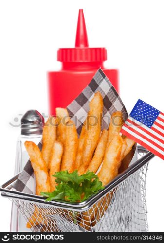 Basket of freshly made southern fries with ketchup and salt black paper and american flag on white studio background
