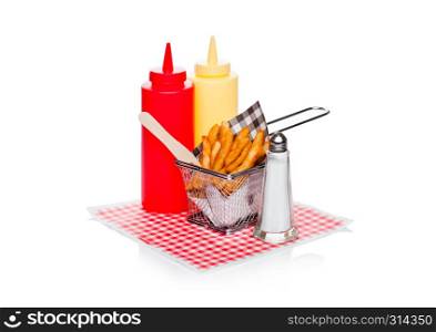 Basket of freshly made southern fries with ketchup and salt black paper on red restaurant paper background