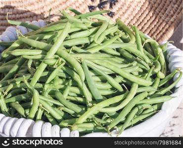 basket of green beans. Fruits and vegetables in season exposed in a street market