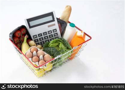 Basket of groceries and calculator