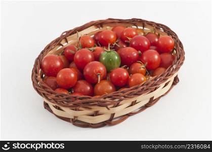basket of tomatoes on white background