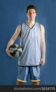 Basket player young man over blue grunge background