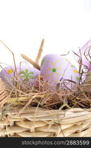 basket wicker with decoration easter eggs on hay