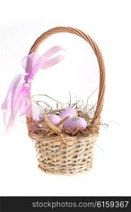 basket wicker with decoration easter eggs on hay