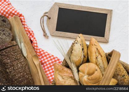 basket with buns near bread blackboard