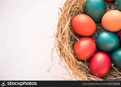 basket with colorfull easter eggs spring concept