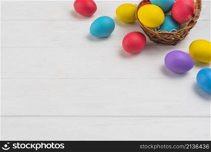 basket with easter eggs wooden table