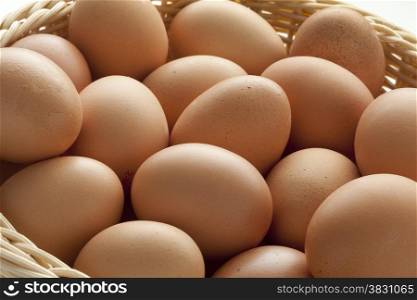 Basket with fresh brown eggs