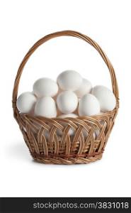 Basket with fresh white eggs on white background