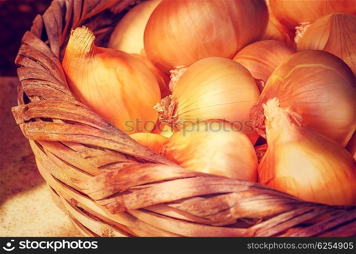 Basket with onions standing in sun light, food background, fresh spicy vegetables, organic nutrition from garden, great harvest, vegetable production