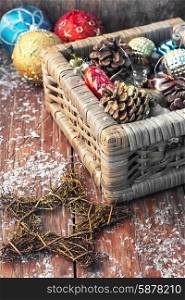 Basket with ornaments on the Christmas tree. Christmas ornaments in wooden wicker box.Photo tinted.Selective focus