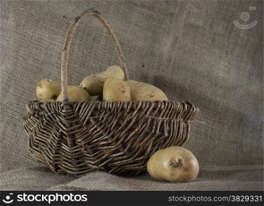 basket with potatoes and jute background