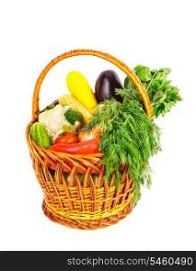 Basket with vegetables and fresh herbs isolated on white