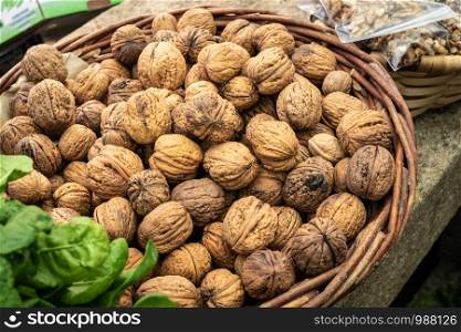Basket with walnuts on a farmers market. Food background