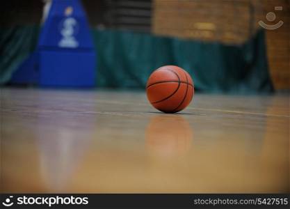 Basketball ball, board and net on black background in gym indoor