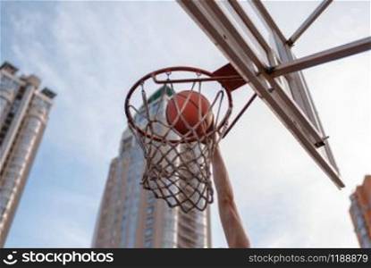 Basketball ball hits the basket outdoor, nobody. Streetball sport, game concept