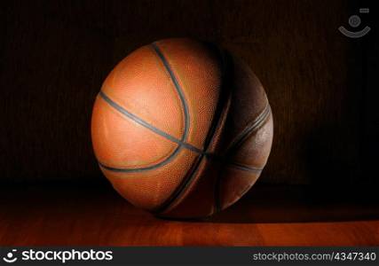 basketball ball in dark on wooden floor