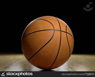 Basketball court wooden floor with ball isolated on black with copy-space