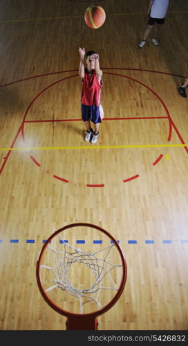 basketball game playeer shooting on basket indoor in gym