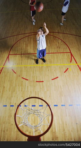 basketball game playeer shooting on basket indoor in gym