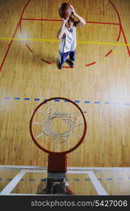 basketball game playeer shooting on basket indoor in gym