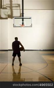 Basketball player alone in basketball court